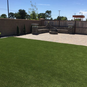 Basalite Seating wall with fire pit and synthetic turf